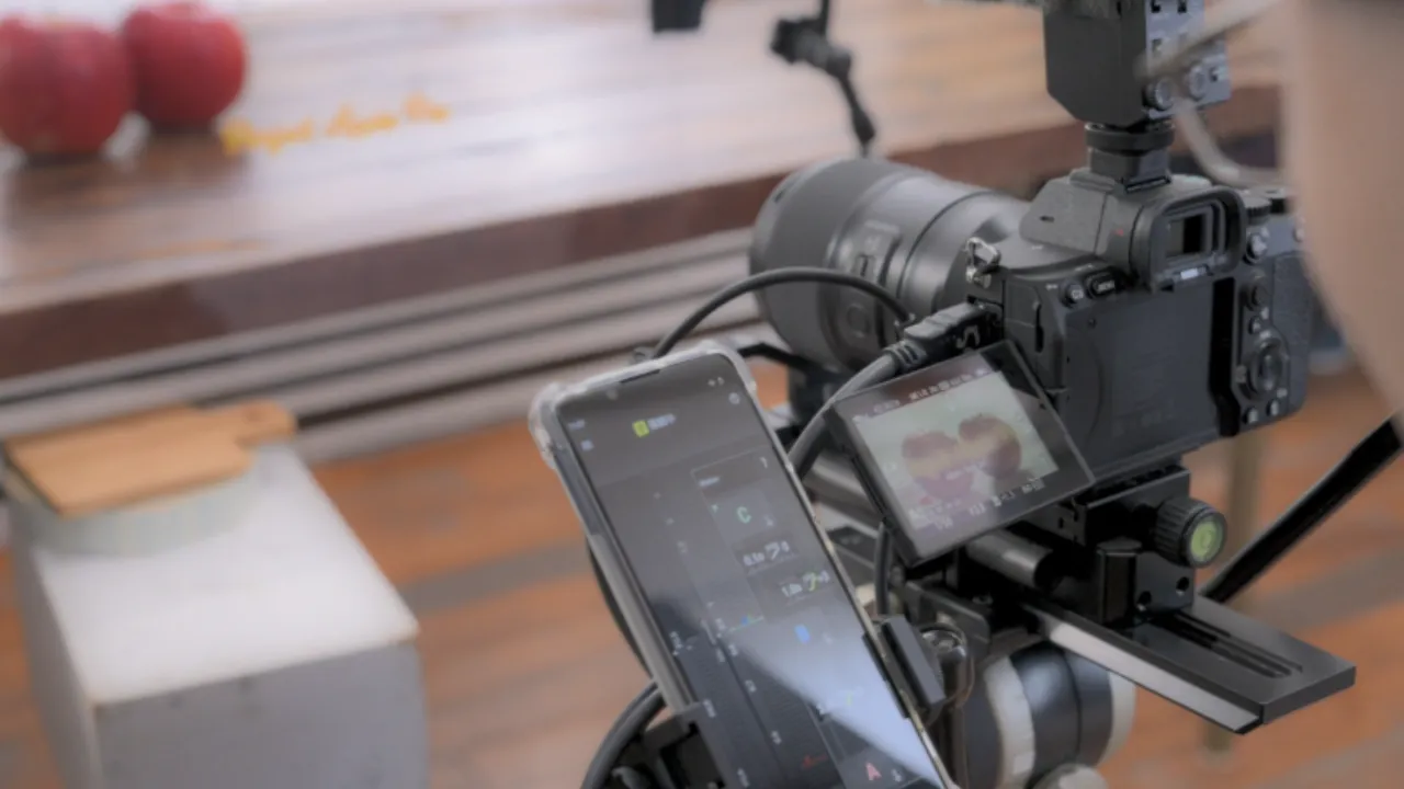 Camera and TAMRON Lens Utility Mobile used for cinematic video focus control
