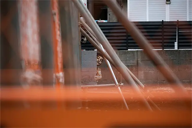 Outdoor scene viewed through blurred foreground structures