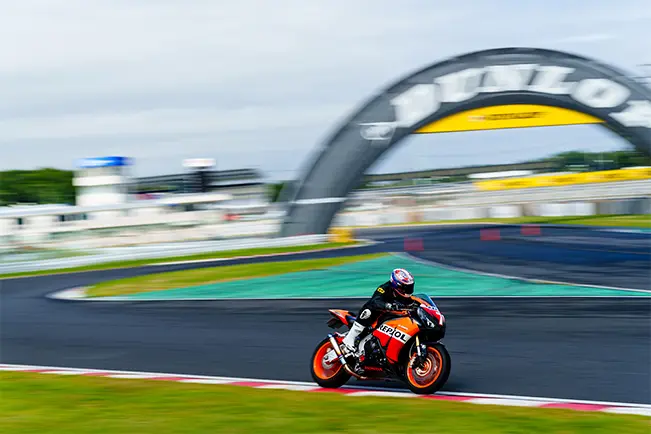 Motorcycle racing on a wet track with motion blur