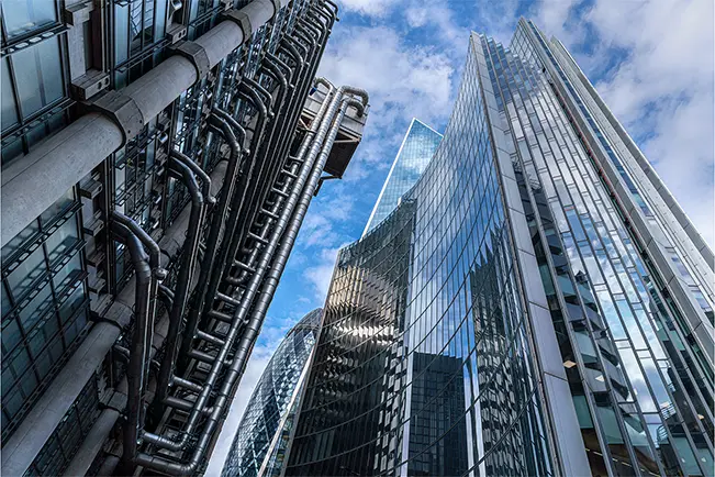 Modern skyscrapers viewed from below against a blue sky