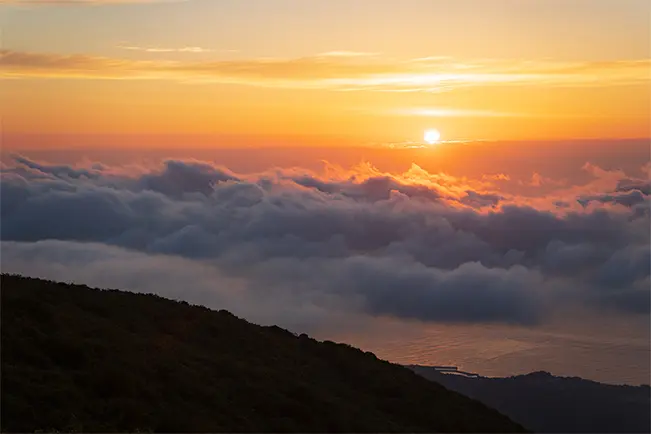 Sunset above a sea of clouds viewed from a mountain