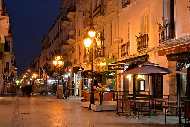 Historic city street illuminated by warm lights at night