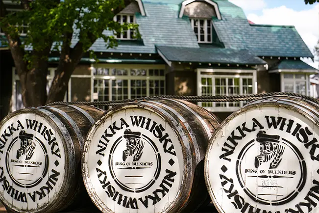 Whiskey barrels arranged outside a building
