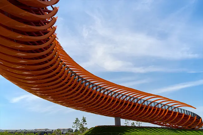 Modern curved architectural structure against a blue sky