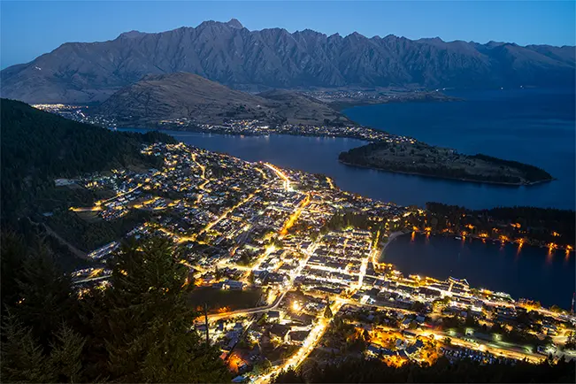 Night time city lights view on a mountain top