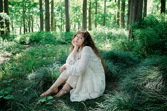 Woman sitting in a forest