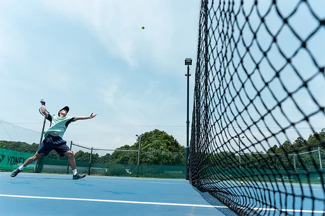 Person playing tennis on a court