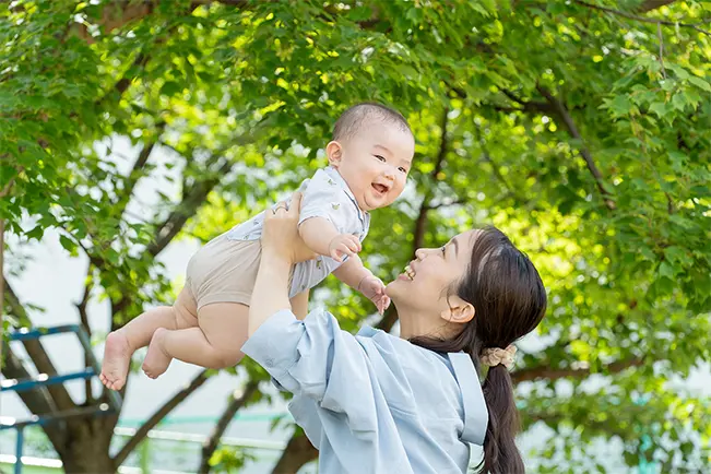 Parent holding a baby outdoors