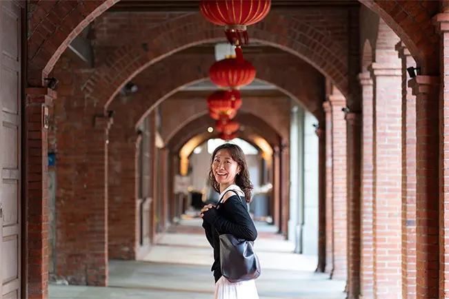 Person walking through an arched corridor