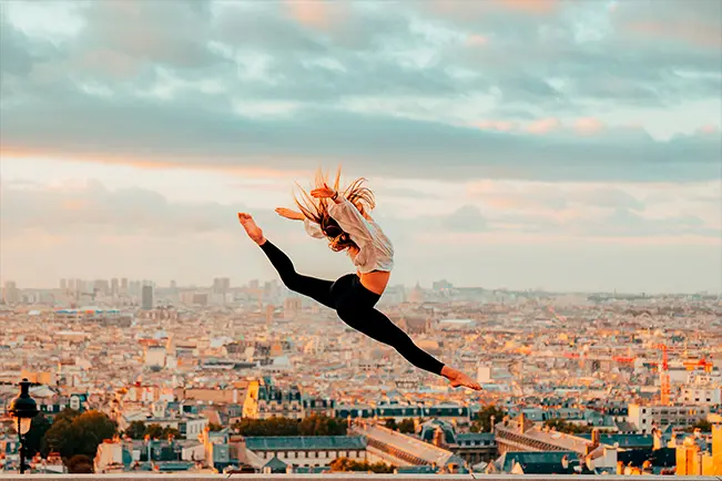 Person performing a jump over a city