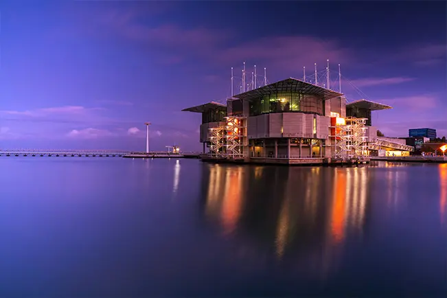 Modern building beside the water at dusk