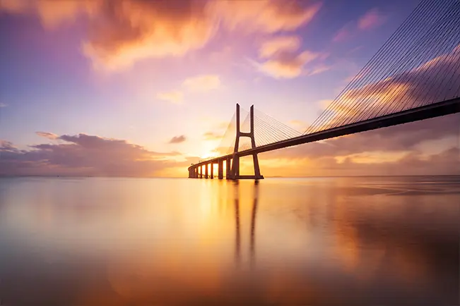 Bridge over the water at sunset